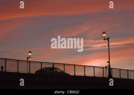 Sunset over bridge with passing car in Southern France Stock Photo