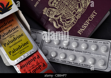 Anti malarial tablets next to a UK passport Stock Photo