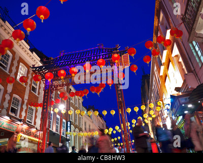 Chinese lanterns lit up on a busy night in Chinatown Soho London UK Stock Photo