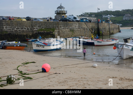 Boats moored on St Ives Harbour Beach at low tide, St Ives, Cornwall England UK Stock Photo