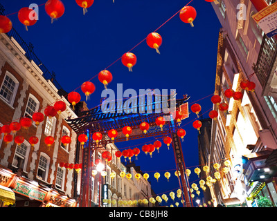 Chinese lanterns lit up on a busy celebration night in Chinatown Soho London UK Stock Photo