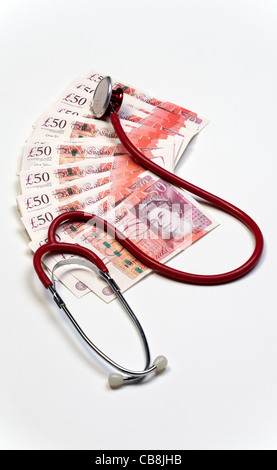 Stethoscope resting on top of cash new £50 pound bank notes Stock Photo
