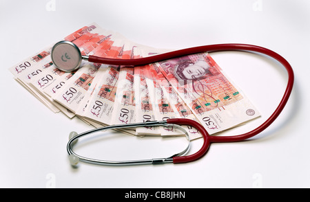 Stethoscope resting on top of cash new £50 pound bank notes Stock Photo