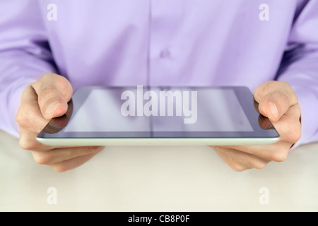 Closeup shot of businessman hands are holding and using digital tablet pc. Shallow depth of field on fingers. Stock Photo