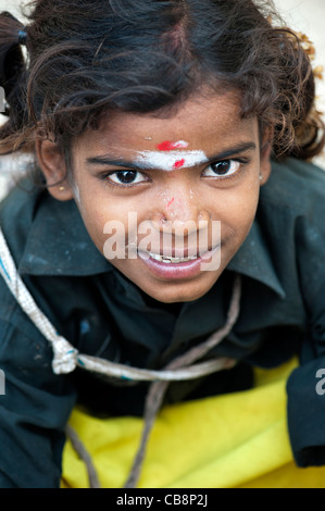 Poor Indian beggar girl looking up. Selective focus Stock Photo