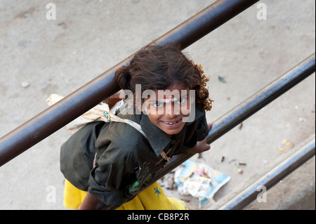 Poor Indian beggar girl looking up, selective focus Stock Photo