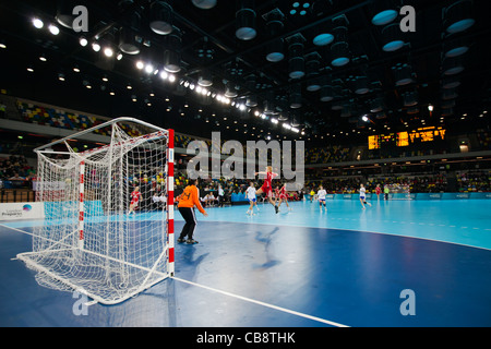Patrycja KULWINSKA (POL) shooting at Zuzana SKOLKOVA (SVK) in goal, Poland v Slovakia, Women's London Handball Cup. Stock Photo