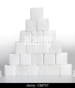 Studio photography of a pyramid made of lump sugar pieces in light gradient back Stock Photo