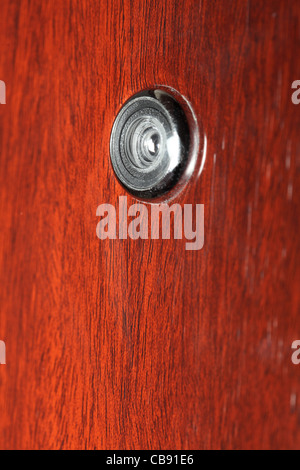 Peephole on wooden door - judas hole spyhole Stock Photo