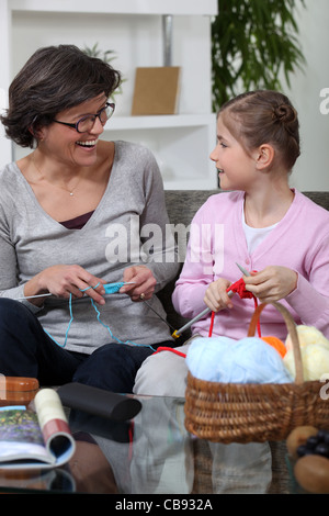 Grandmother knitting with her granddaughter Stock Photo