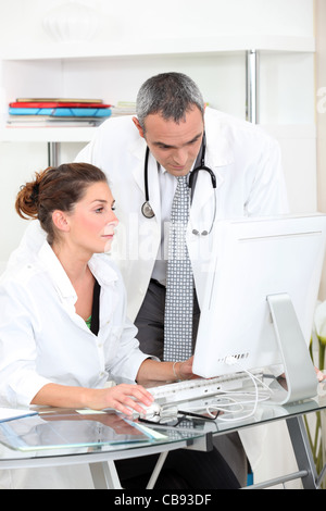 Doctors looking at a computer Stock Photo