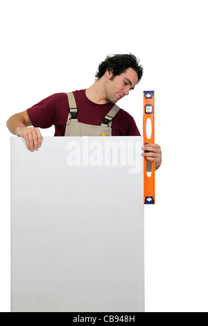 Workman using a spirit level Stock Photo