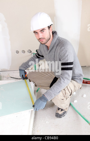 Laborer in room under construction Stock Photo