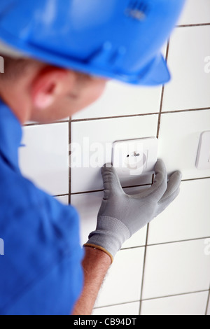 Electrician fitting plug socket Stock Photo