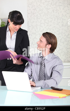 two office colleagues examining documents Stock Photo