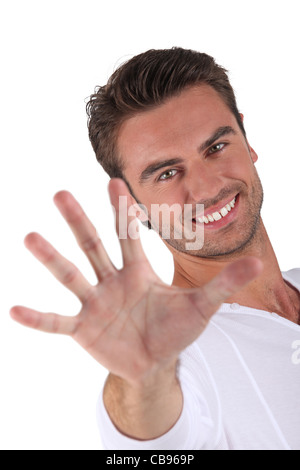 Young man holding out hand Stock Photo