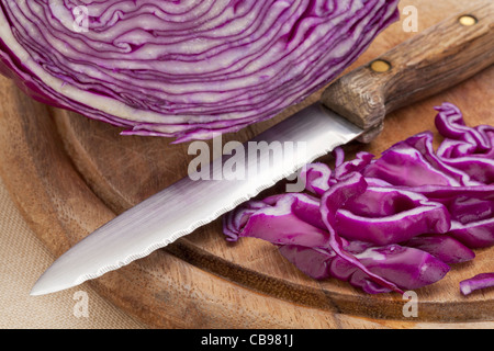 red cabbage and knife on a wooden cutting board Stock Photo