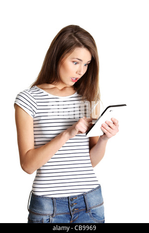 Front view portrait of a young surprised caucasian teen counting on calculator, on white. Stock Photo