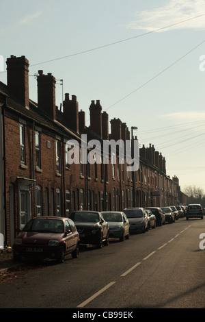 Terraced houses in Blackheath near Birmingham with cars parked on the road. Stock Photo