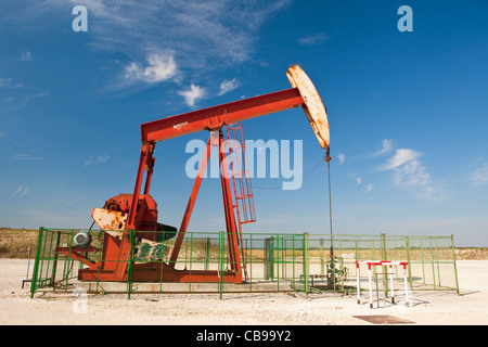 pumpjack (nodding donkey, pumping unit, horsehead pump, beam pump, sucker rod pump (SRP), grasshopper pump ) Stock Photo