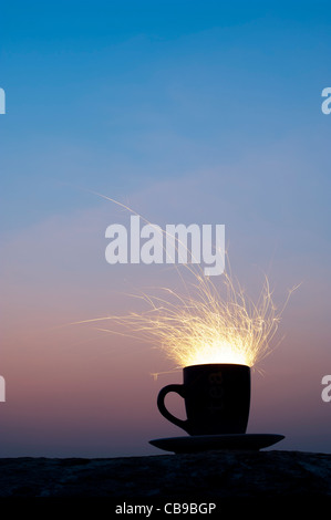 Fiery storm in a teacup concept. Fire cracker in a cup at night Stock Photo