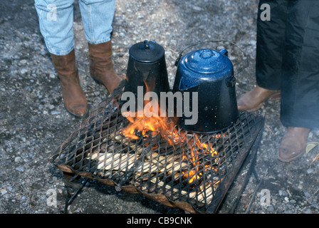 cowboy coffee pot boiling over open campfire burn steam cook