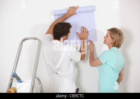 Man and woman choosing wallpaper Stock Photo