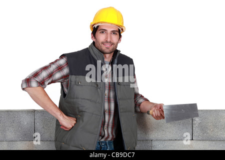 mason holding a trowel Stock Photo