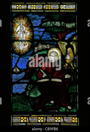 Stained glass window by the Kempe Studios depicting St John on Patmos writing the Book of Revelation, St Etheldreda's Church, West, Quantoxhead Stock Photo