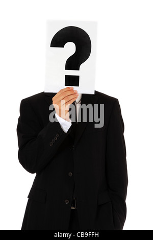 Businessman holding question mark in front of his head. All on white background. Stock Photo