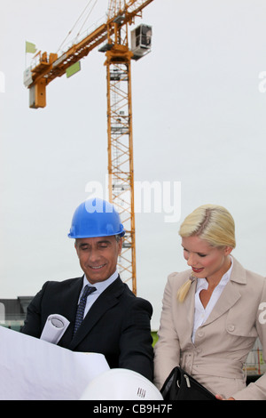 Two architect checking the plans onsite. Stock Photo