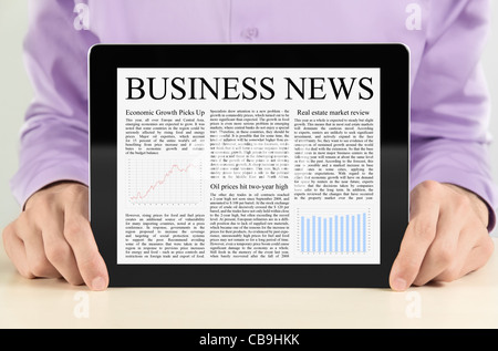 Businessman showing digital tablet pc with business news on screen. Stock Photo