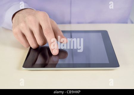 Closeup shot of businessman hand are touching on digital tablet pc. Shallow depth of field on finger. Stock Photo