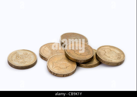 a small pile of british one pound coins isolated on a white background Stock Photo