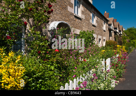 A terrace of Victorian cottages with typically colourful gardens in Well Cross, Edith Weston, Rutland, England Stock Photo