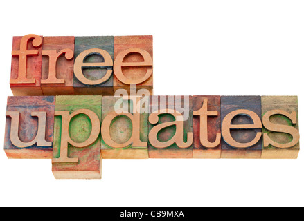 free updates - isolated text in vintage wood letterpress printing blocks Stock Photo