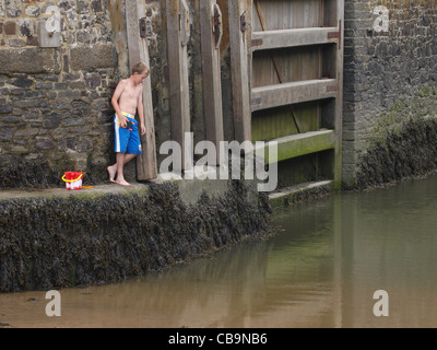 Young boy crab fishing, Cornwall, UK Stock Photo
