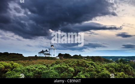 Storm clouds moving over Cromer Lighthouse on a summers evening Stock Photo