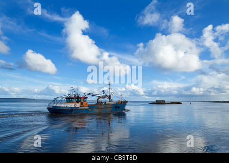 Fishing Boat heading out to sea on the Slaney River, Wexford Town, County Wexford, Ireland Stock Photo