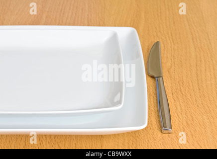White plates on wooden table Stock Photo