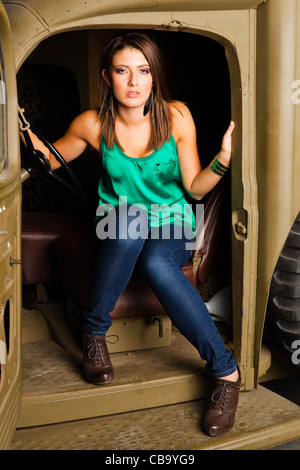 A young Caucasian woman amongst military memorabilia Stock Photo