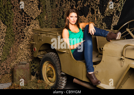 A young Caucasian woman amongst military memorabilia Stock Photo