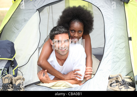 interracial couple in a canvas tent Stock Photo