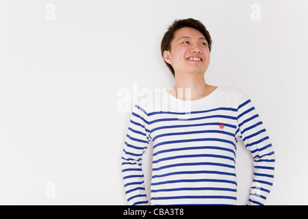 Young man looking away and smiling Stock Photo