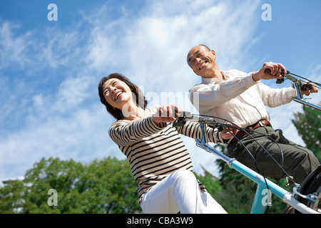 Mature couple riding bicycle Stock Photo