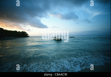 Bangka or outrigger boat at sunset at Sanghiang Bay of Nusa Lembongan, Indonesia Stock Photo