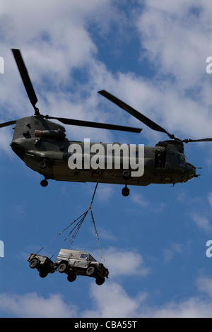 Boeing Chinook helicopter carrying army truck and trailor at Farnborough International Airshow, July 2010 Stock Photo