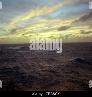 Sunset or sunrise, out at sea, on the ocean waves. Stock Photo