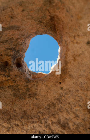 blue sky seen through a hole in the granite on the island of La Maddalena in Sardinia Stock Photo