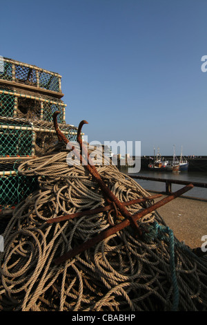 Lobster pots and fishermen's ropes on the Quayside at Bridlington harbour in the evening sun Stock Photo